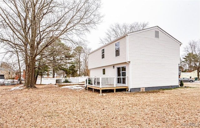 back of house with a wooden deck