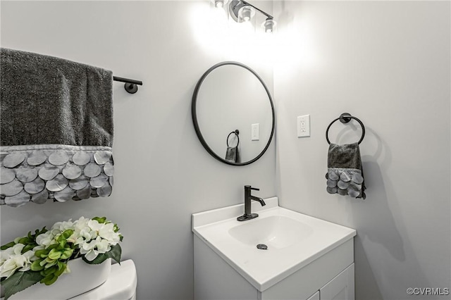 bathroom with toilet and vanity