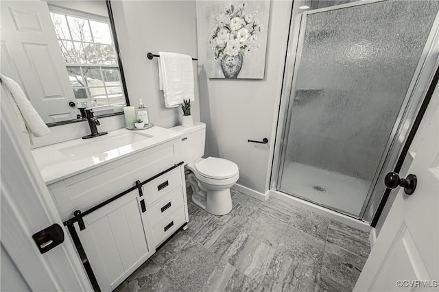 bathroom with a shower with shower door, toilet, and vanity