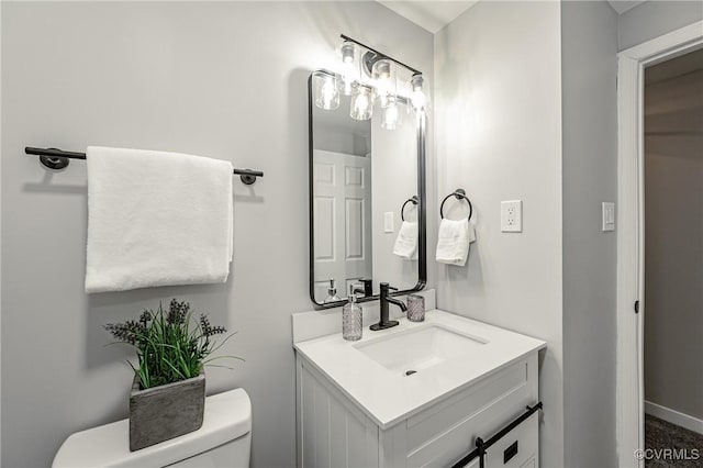 bathroom with toilet and vanity