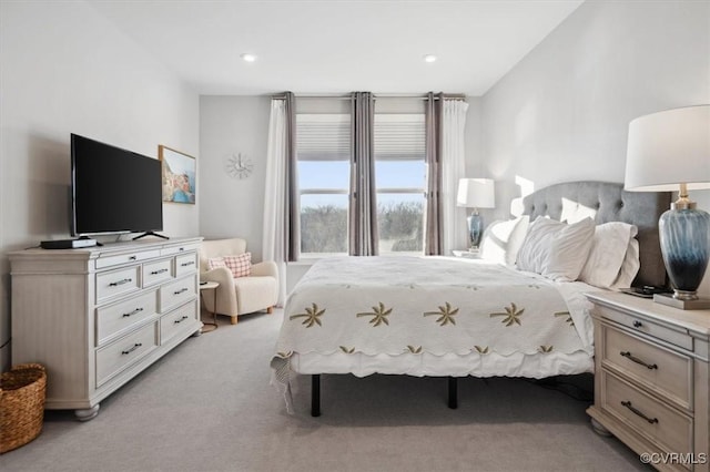 bedroom featuring light colored carpet