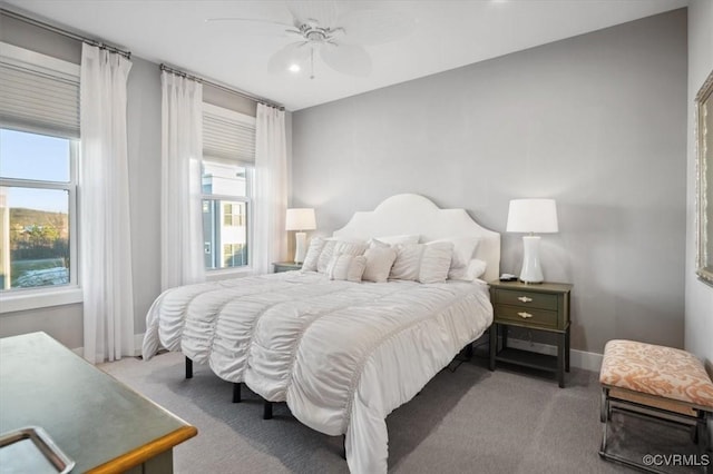 bedroom featuring multiple windows, carpet flooring, and ceiling fan