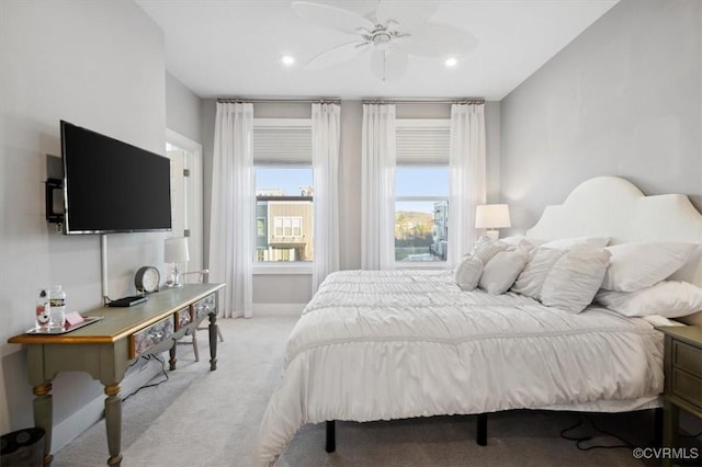 bedroom featuring light carpet and ceiling fan