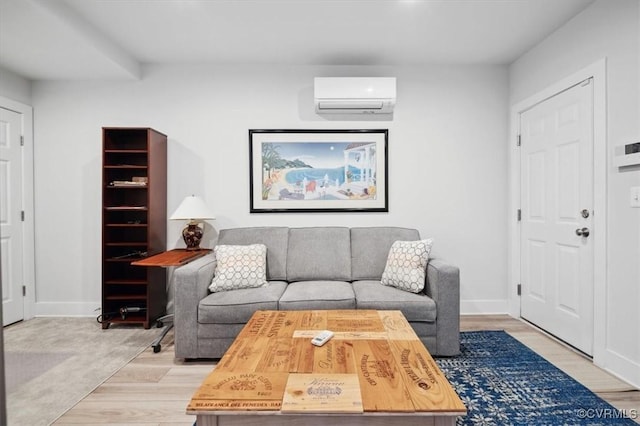 living room featuring a wall mounted AC and light hardwood / wood-style floors