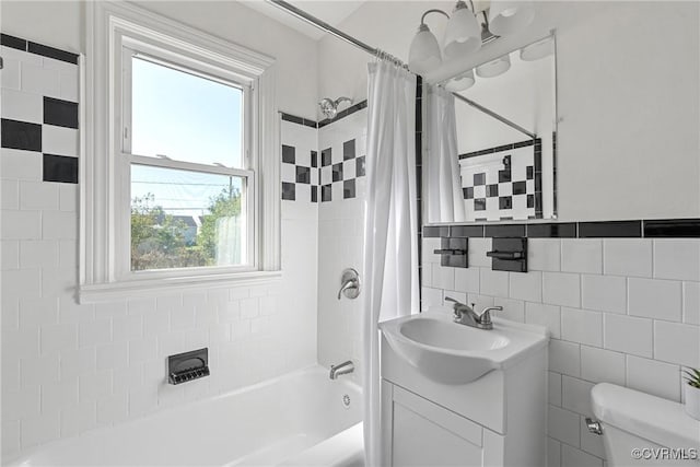 full bathroom featuring toilet, tile walls, vanity, and shower / tub combo with curtain