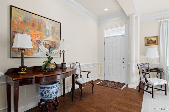 entryway featuring ornate columns, ornamental molding, and dark hardwood / wood-style flooring