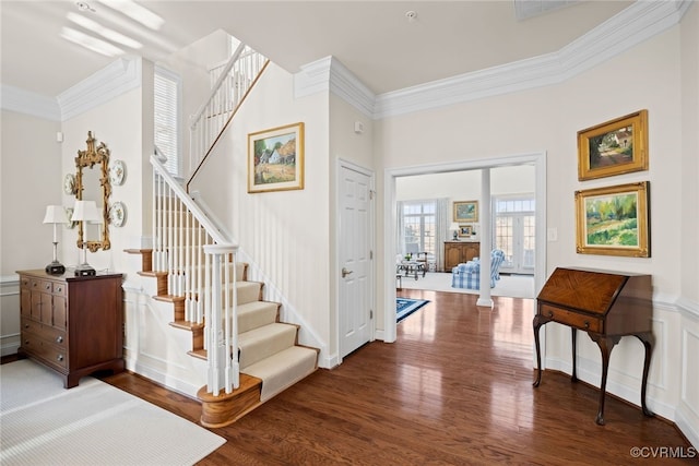 entryway with dark hardwood / wood-style floors, crown molding, and french doors