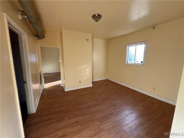 spare room with dark wood-type flooring