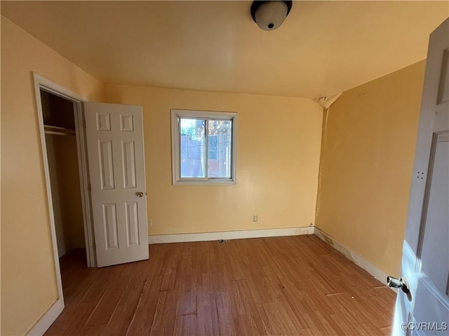 unfurnished bedroom featuring a closet and light hardwood / wood-style flooring