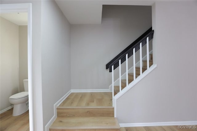 stairs featuring hardwood / wood-style flooring