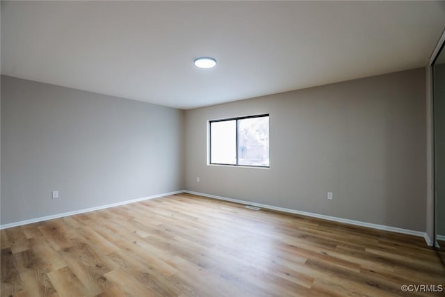 spare room featuring light wood-type flooring