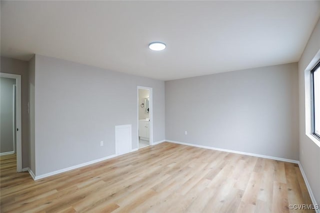 unfurnished room with light wood-type flooring and plenty of natural light