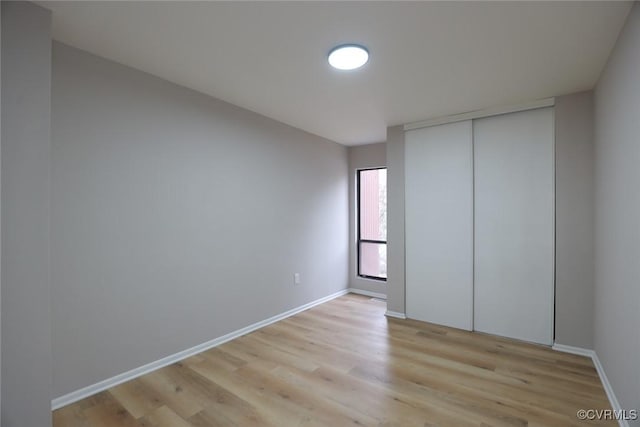 unfurnished bedroom featuring a closet and light hardwood / wood-style flooring