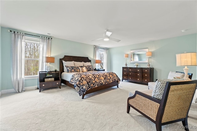 carpeted bedroom featuring ceiling fan and multiple windows