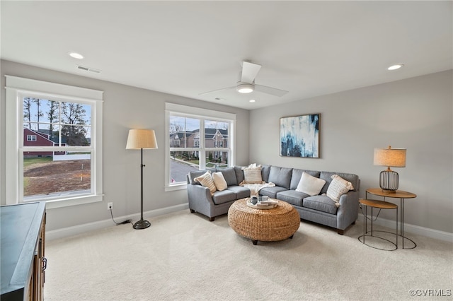 living room featuring light carpet and ceiling fan