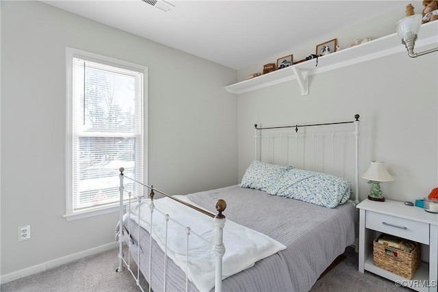 carpeted bedroom with multiple windows