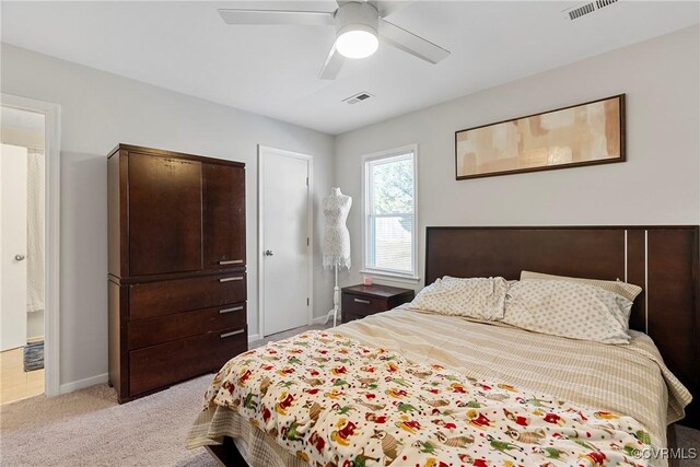 carpeted bedroom featuring ceiling fan and ensuite bathroom