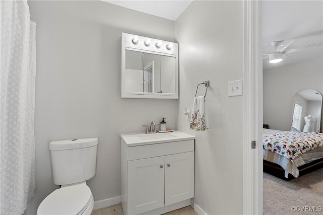 bathroom featuring toilet, ceiling fan, and vanity