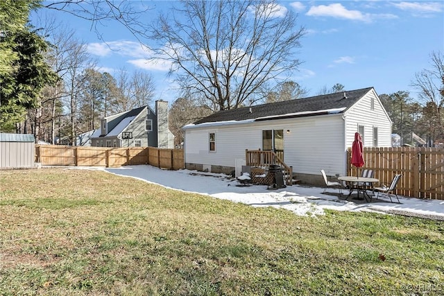 rear view of property featuring a lawn and a patio