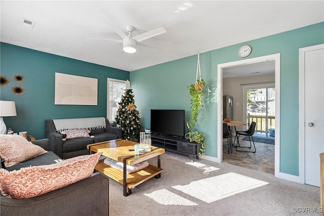 carpeted living room with ceiling fan