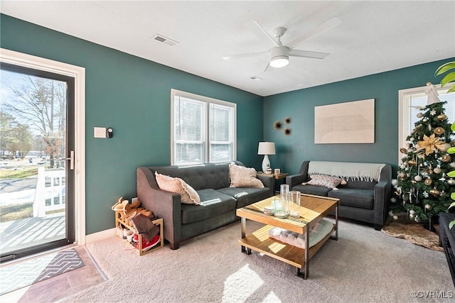 living room featuring ceiling fan and light carpet