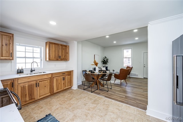 kitchen with a baseboard radiator, sink, electric stove, ornamental molding, and light hardwood / wood-style flooring