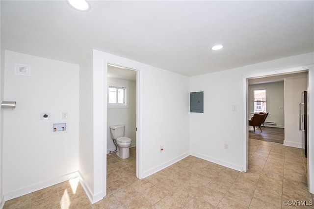 bathroom with toilet and electric panel