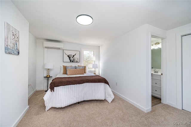 carpeted bedroom with a wall unit AC and ensuite bath