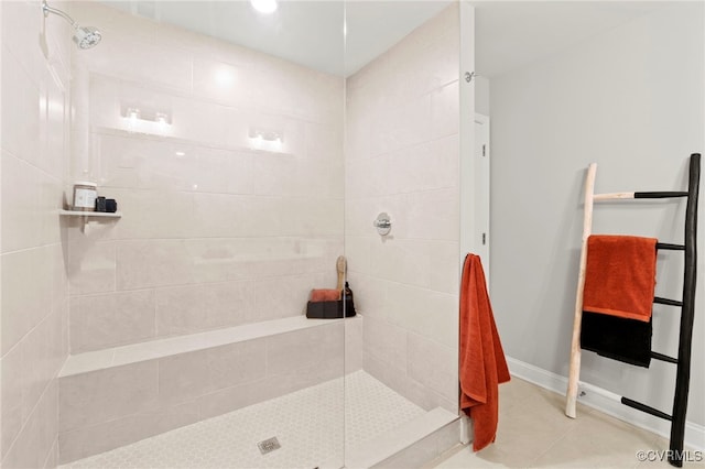 bathroom featuring tile patterned floors and a tile shower