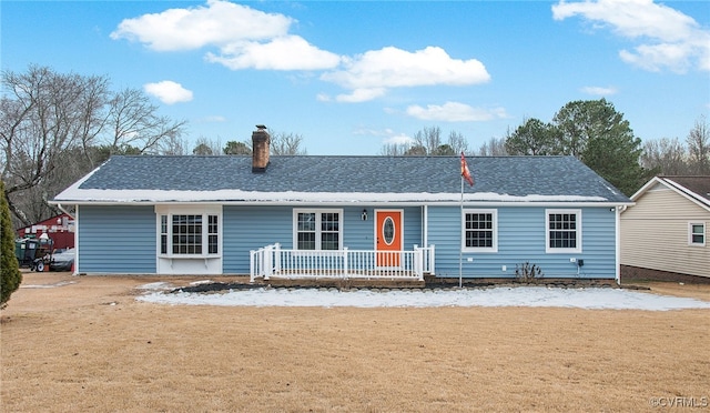 ranch-style house featuring a front lawn and covered porch