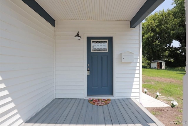 entrance to property featuring a lawn