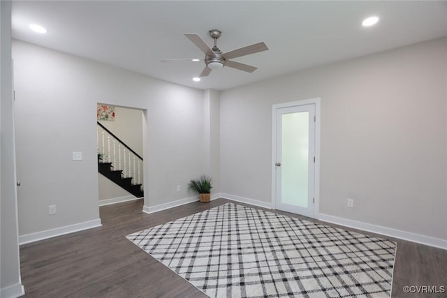 spare room featuring ceiling fan and dark hardwood / wood-style flooring