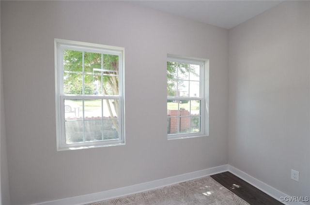 empty room with light wood-type flooring and baseboards