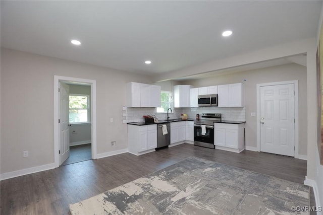 kitchen featuring sink, white cabinetry, appliances with stainless steel finishes, and tasteful backsplash