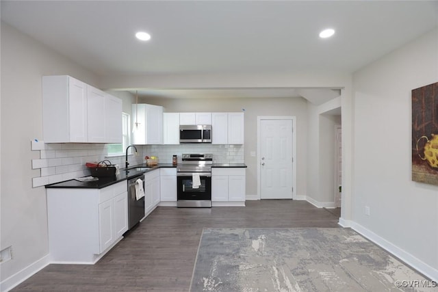 kitchen featuring white cabinets, dark hardwood / wood-style flooring, stainless steel appliances, tasteful backsplash, and sink