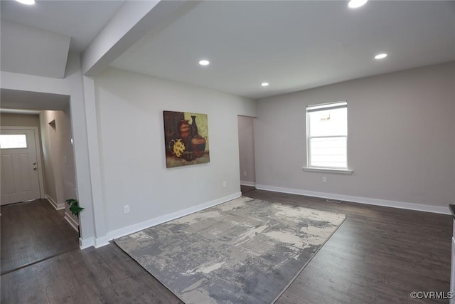 empty room featuring dark hardwood / wood-style flooring