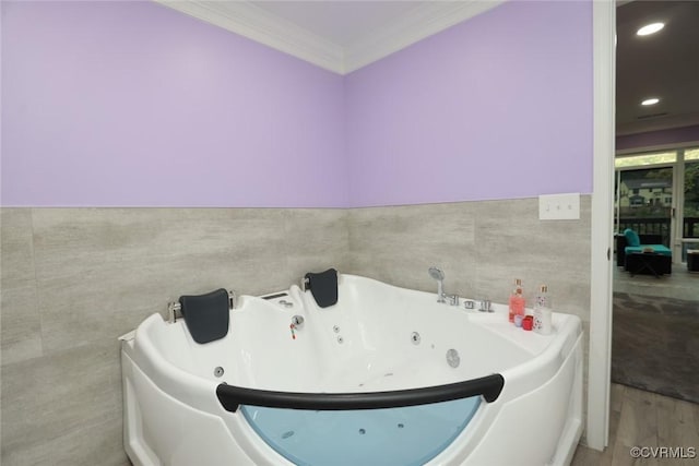 bathroom featuring wood-type flooring, ornamental molding, and a bath