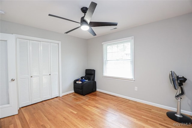 interior space with ceiling fan, light hardwood / wood-style flooring, and a closet