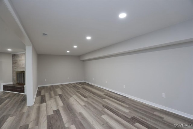 unfurnished living room with a fireplace and light hardwood / wood-style floors