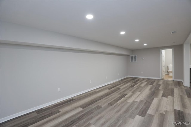 basement with light hardwood / wood-style floors