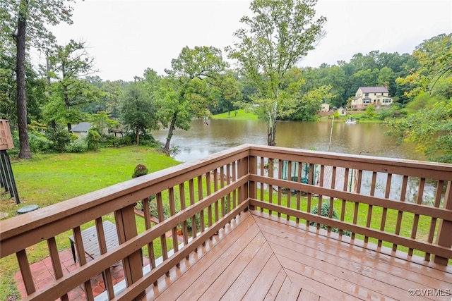 wooden deck with a yard and a water view