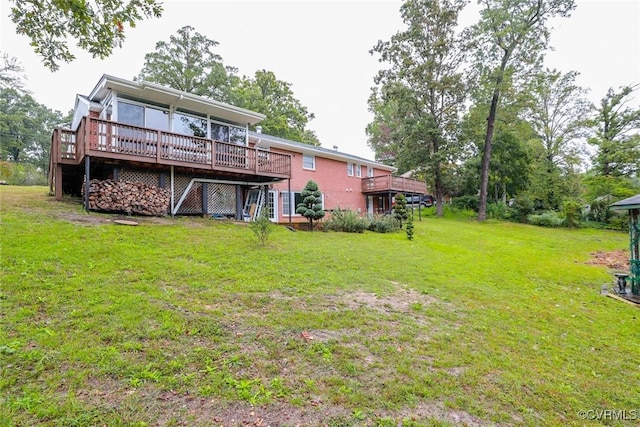 rear view of house with a lawn and a deck