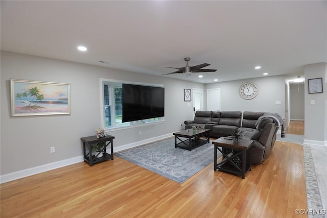 living room with ceiling fan and light hardwood / wood-style floors