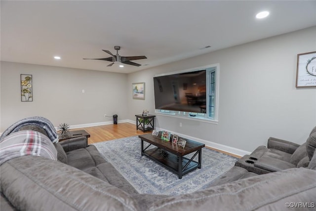 living room featuring ceiling fan and wood-type flooring