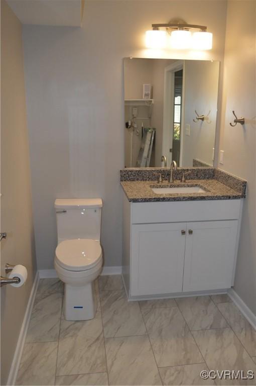 bathroom with toilet and vanity