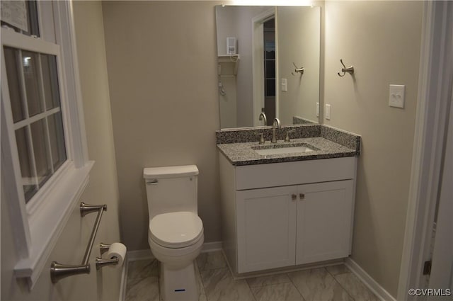 bathroom featuring toilet and vanity