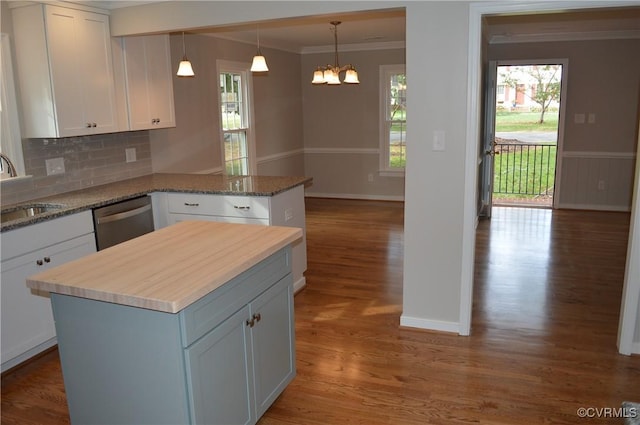 kitchen featuring dishwasher, white cabinetry, a center island, and sink