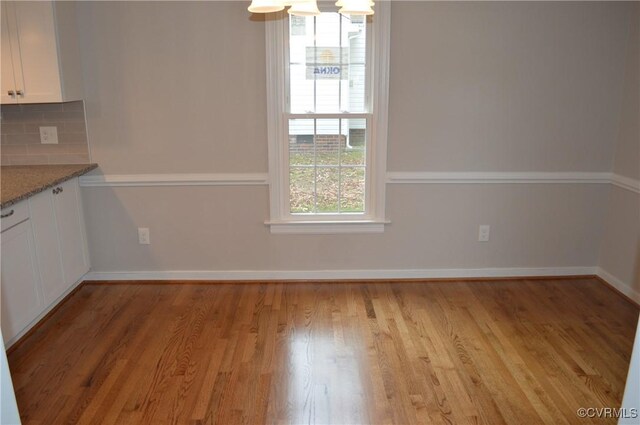 unfurnished dining area featuring light hardwood / wood-style floors