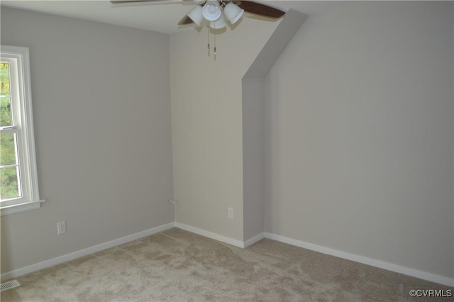 spare room with light colored carpet and a wealth of natural light