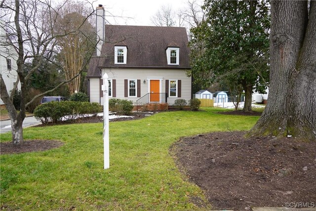 cape cod-style house with a front lawn